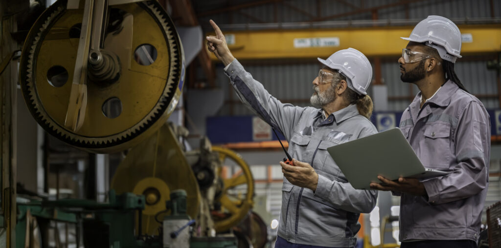 engineers inspecting machinery factory